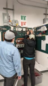 Two electricians working on a lab